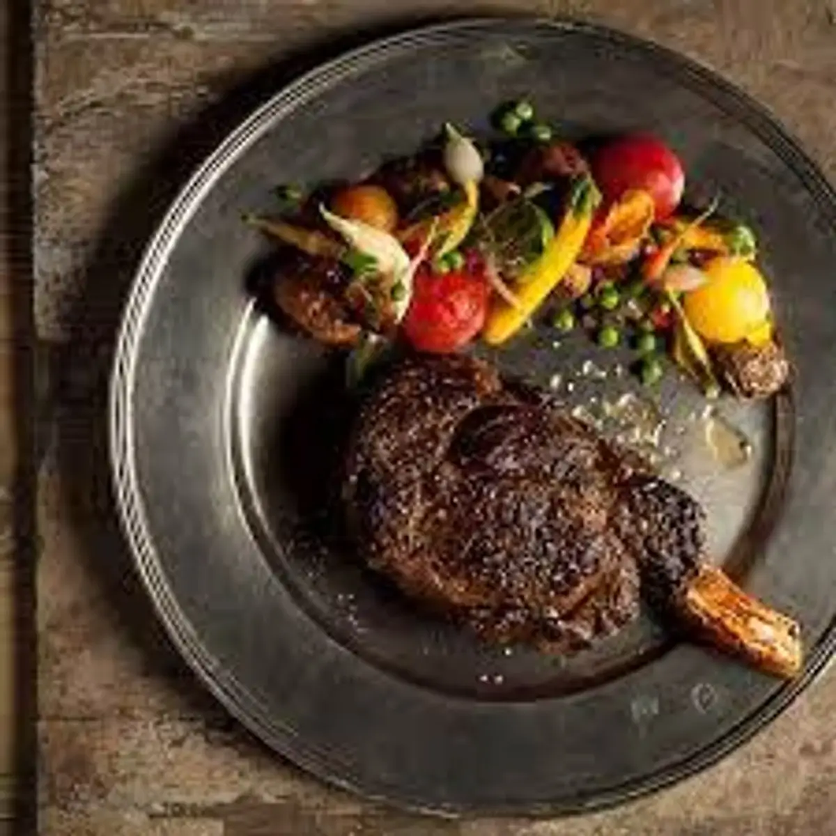 Grilled steak with vegetables plated at Mico Restaurant in Grand Bohemian Hotel Charlotte