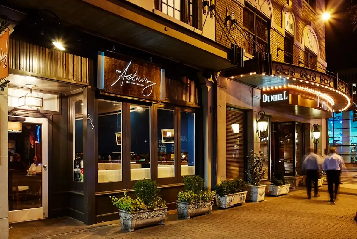 The Asbury restaurant entrance in Uptown Charlotte with outdoor lighting and evening ambiance