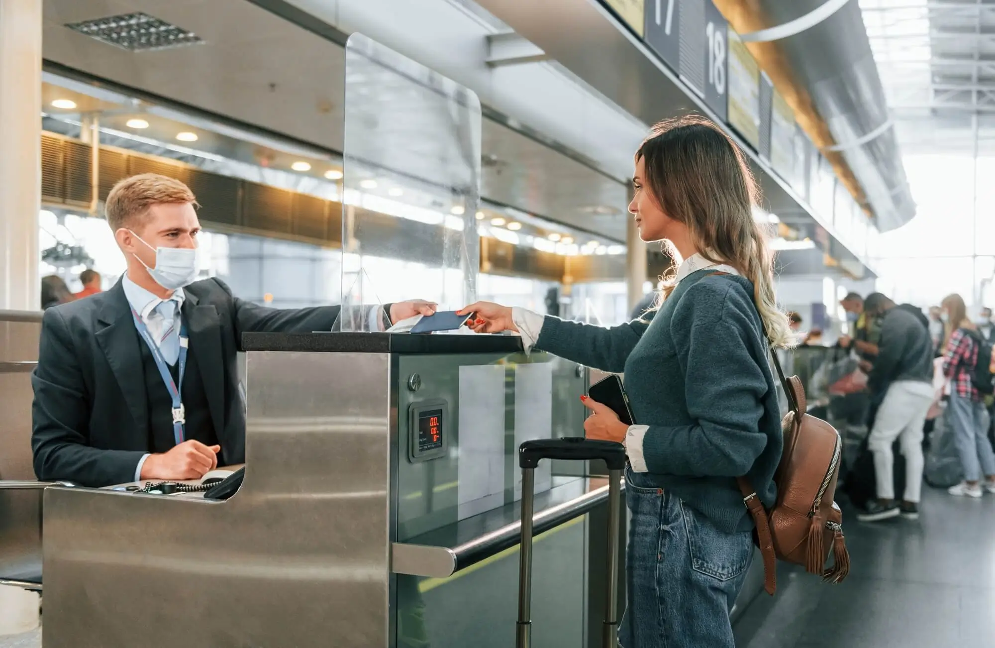 Airport security check passenger showing boarding pass TSA screening travel