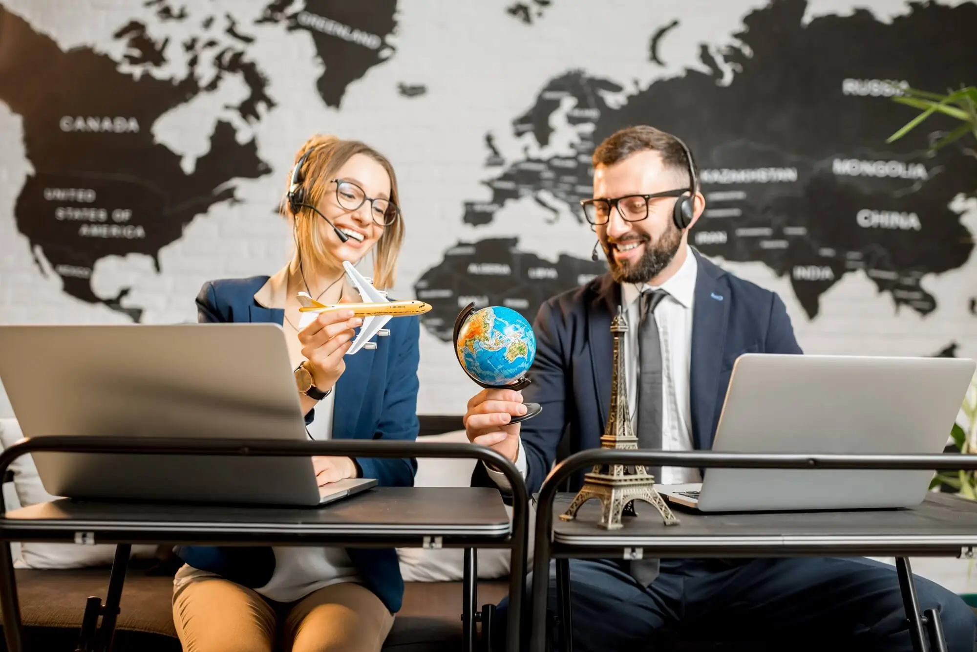 Travel agents planning trips with globe and airplane model, airport transportation and travel car service in Charlotte NC