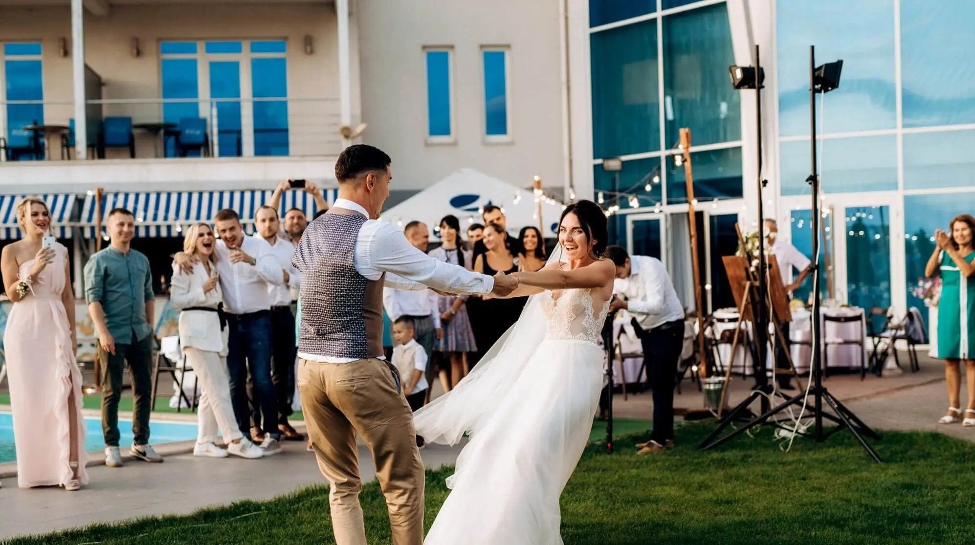 Bride and groom dancing at wedding venue in Charlotte NC with guests, luxury wedding car service Charlotte NC