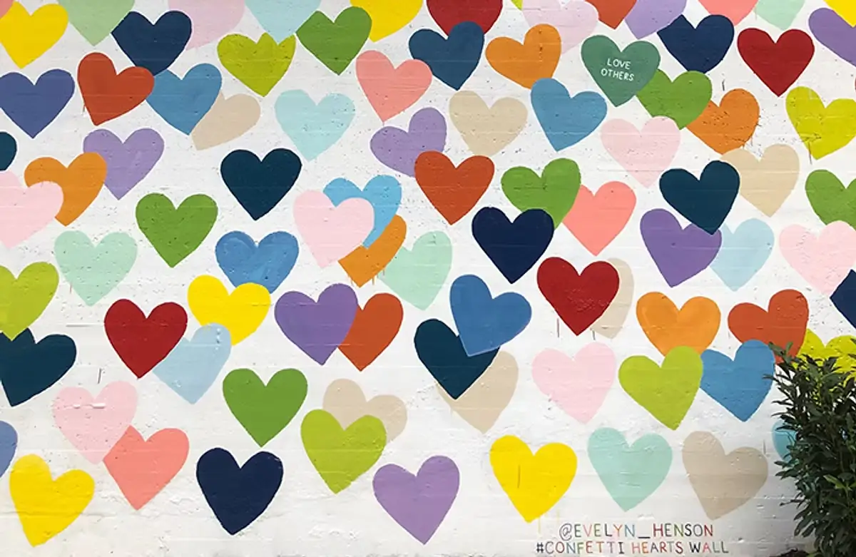 Confetti Hearts Wall mural in Charlotte featuring multicolored hearts on a white background