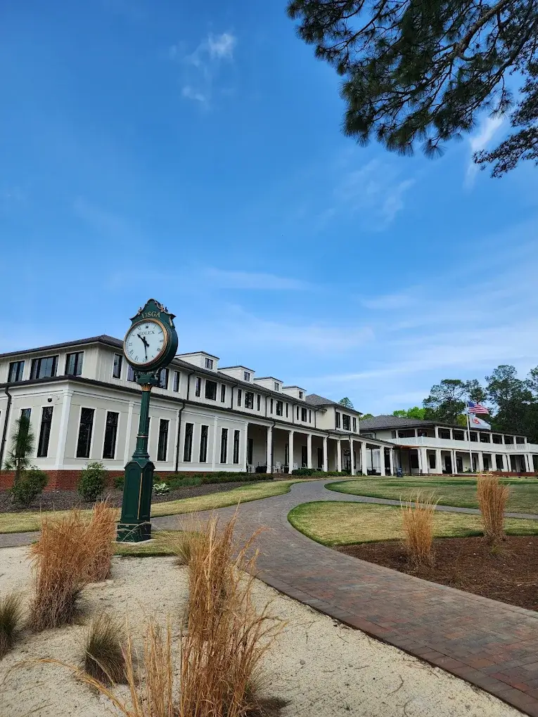 USGA Pinehurst clubhouse and clock for golf travel near Charlotte with VOY Black Car service