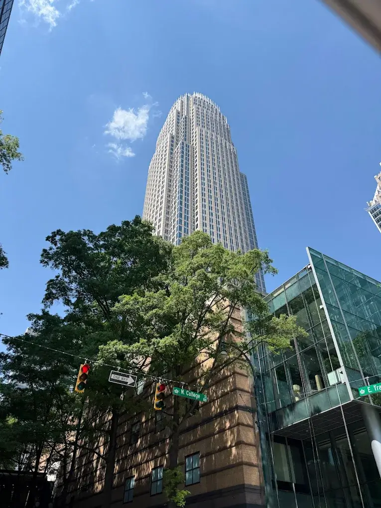 A tall Uptown Charlotte skyscraper viewed from street level, symbolizing the redevelopment of the former Epicentre into the new “Queen City Quarter”