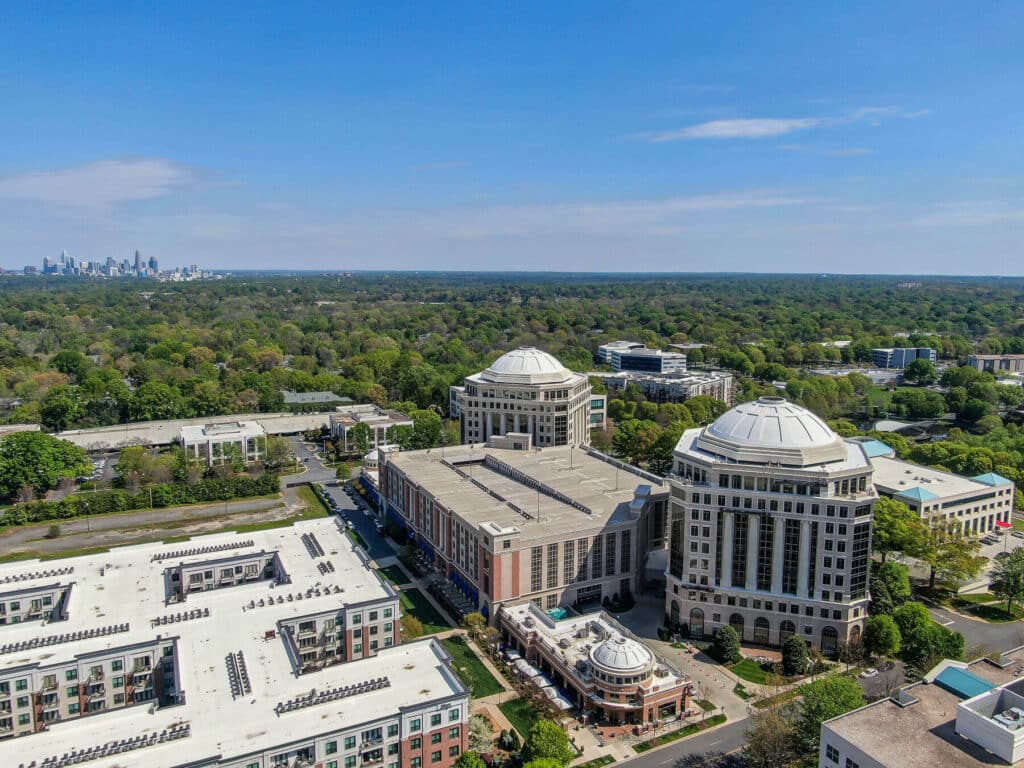 Aerial view of SouthPark Charlotte featuring upscale office buildings, shopping areas, and surrounding greenery