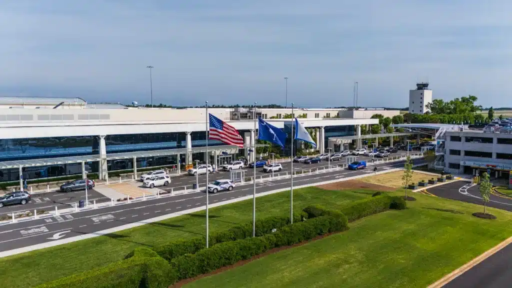 Greenville-Spartanburg International Airport terminal exterior with flags and roadway entrance