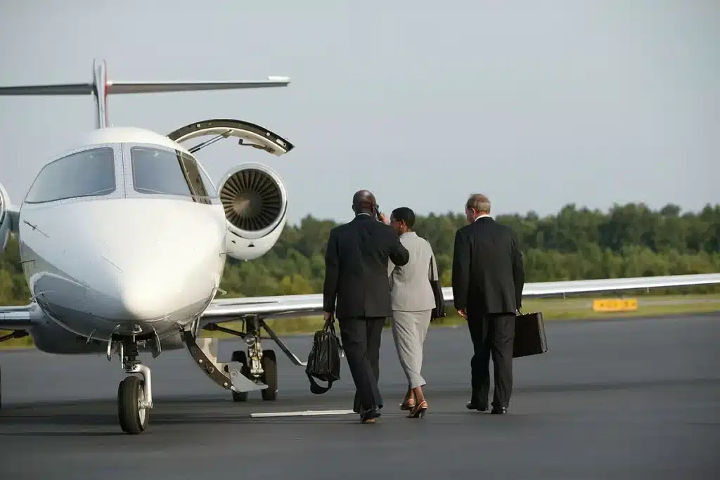 Corporate travelers boarding private jet for business travel