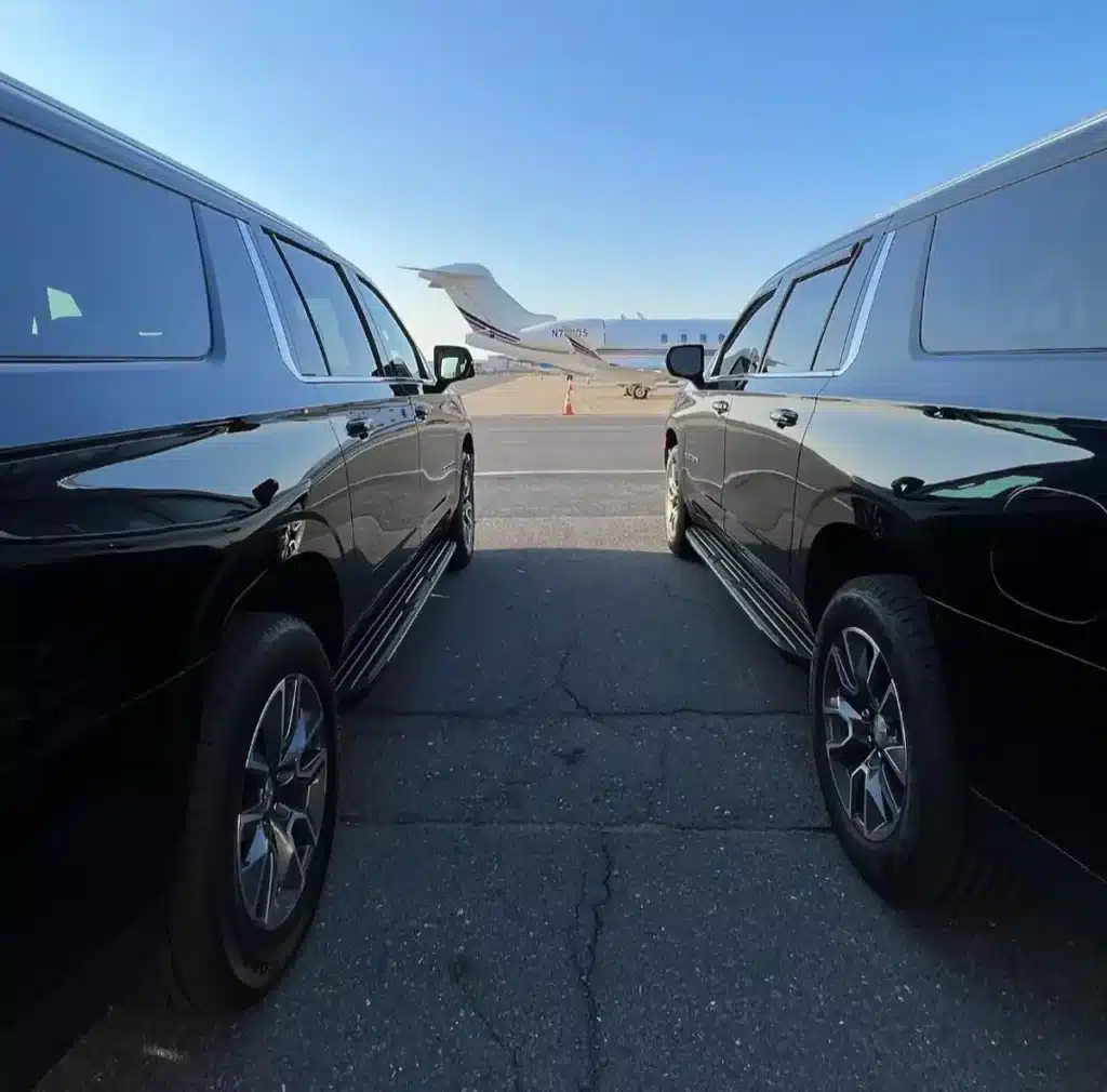 Luxury black SUVs airport transfer near private jet in Waxhaw NC