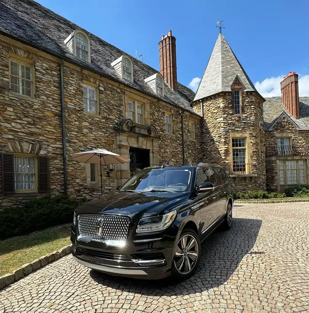 Charlotte limo service for airport transfers – luxury black SUV parked outside upscale home