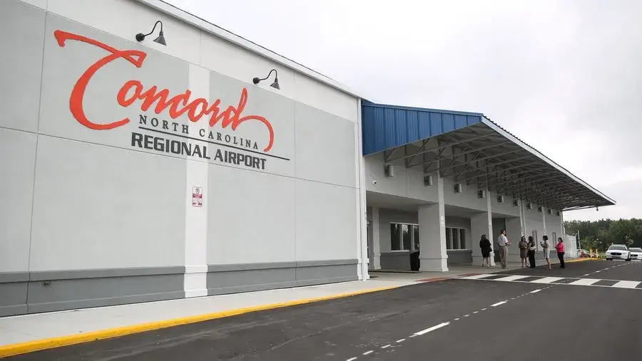Concord Regional Airport terminal entrance in North Carolina with passengers outside