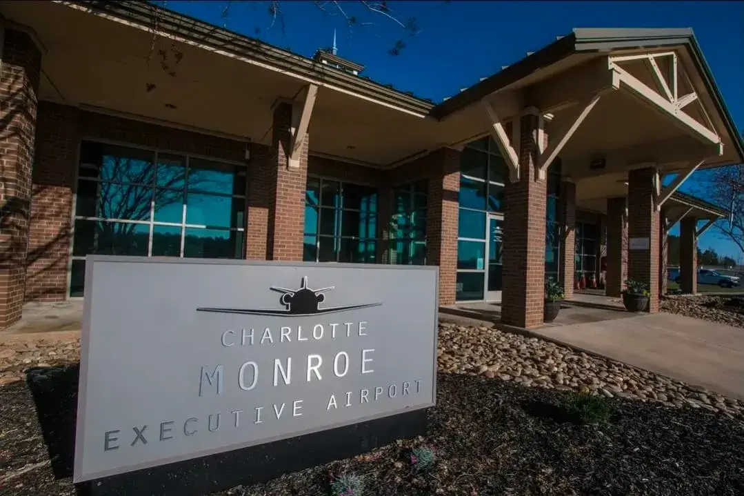 Charlotte Monroe Executive Airport entrance sign with terminal building in North Carolina